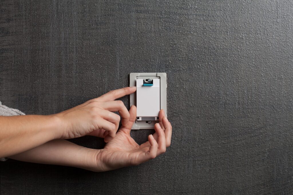 Deako light switch being plugged in.